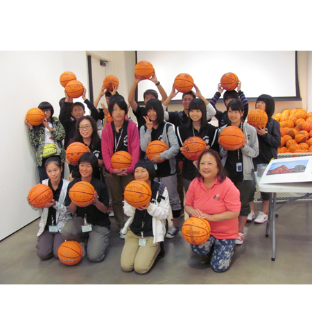 Pyramid project 3, participants showing off the basketballs they decorated