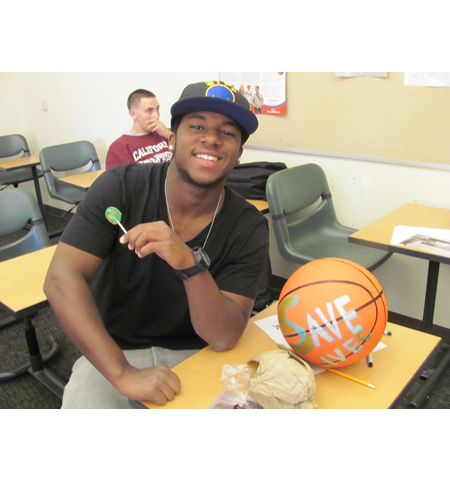 Pyramid project 3, a participant showing off the basketball they decorated