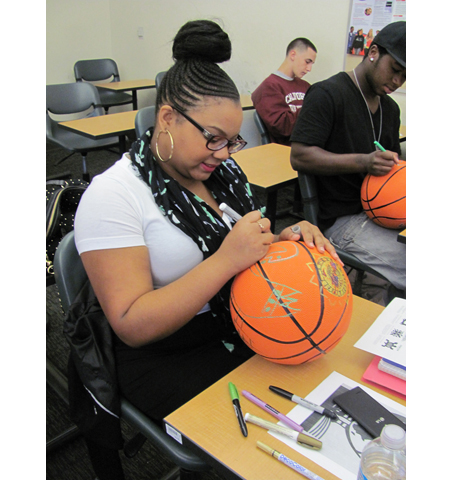 Pyramid project 3, participants decorating basketballs for the pyramid