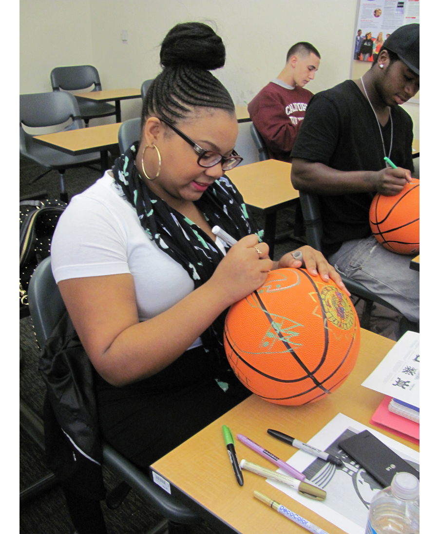 Participants in David Huffman's project Pyramid 3, drawing on basketballs