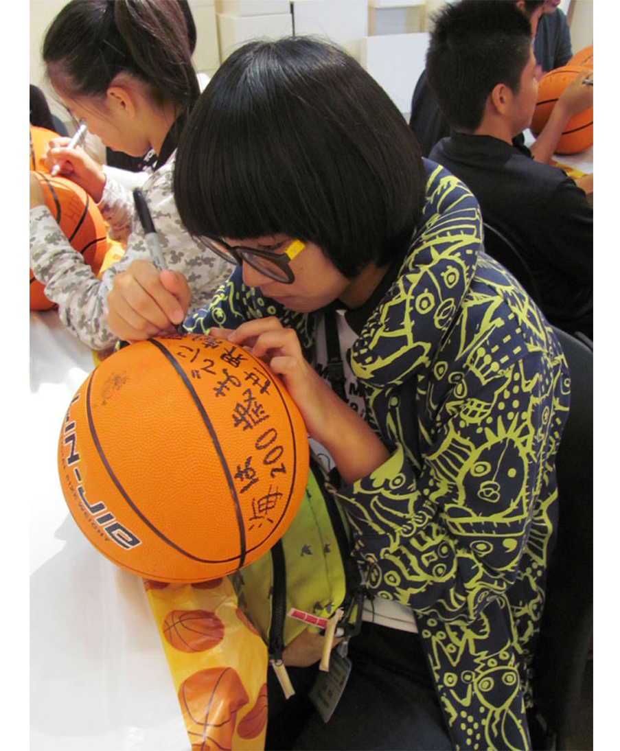 Participants in David Huffman's project Pyramid 3, drawing on basketballs