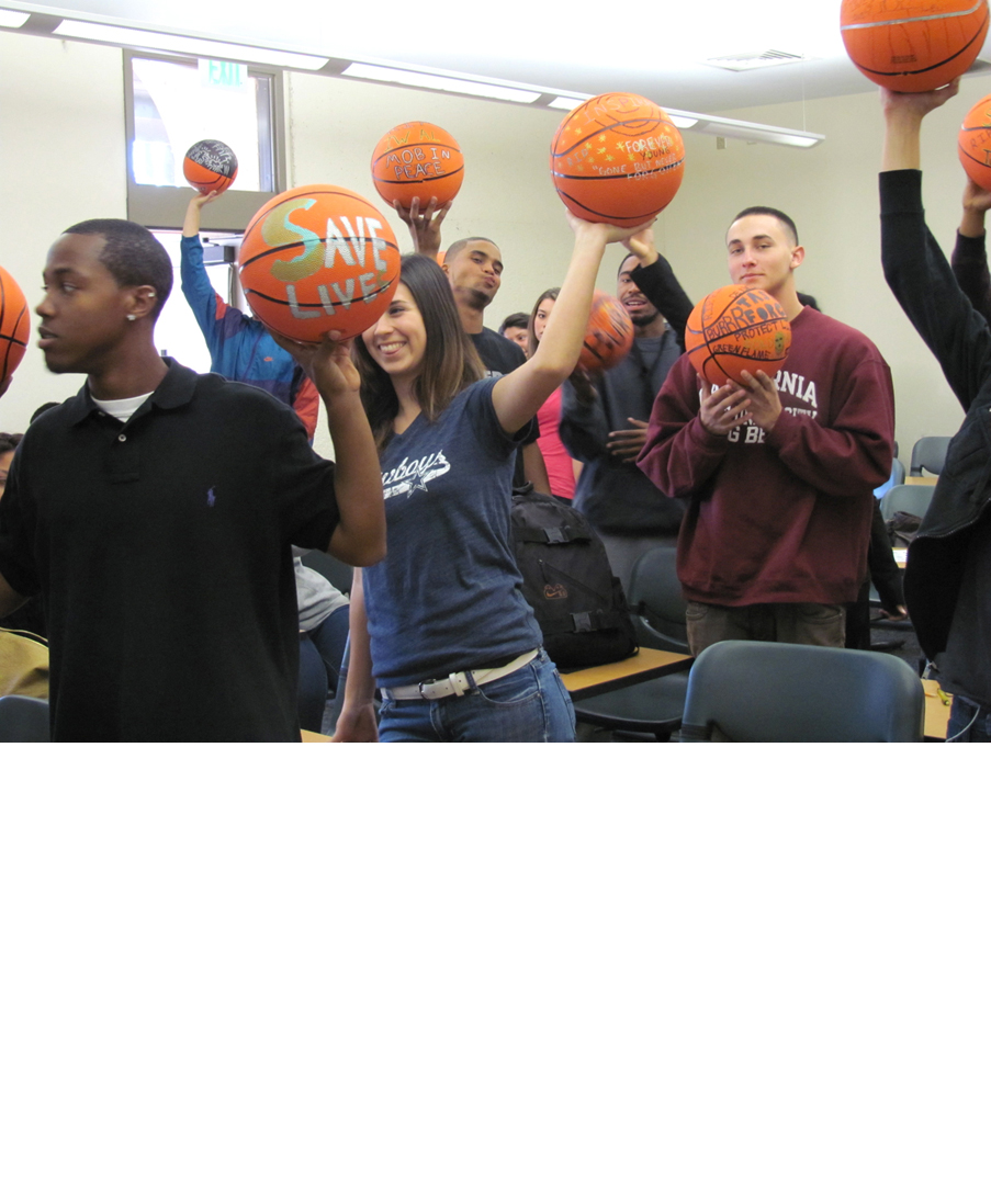 Participants in David Huffman's project Pyramid 3, showing the drawings they made on basketballs